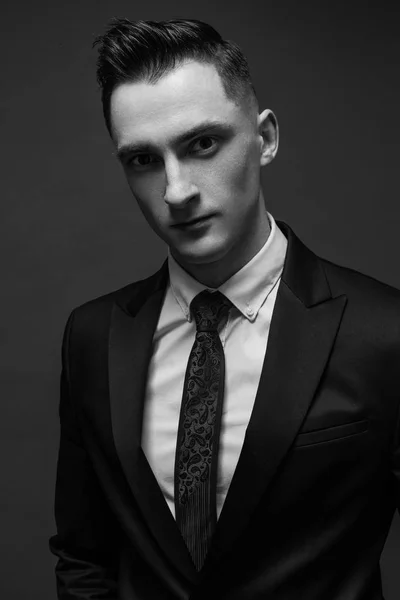 young man in elegant suit posing. Business style. Male beauty, fashion. Hairstyle.