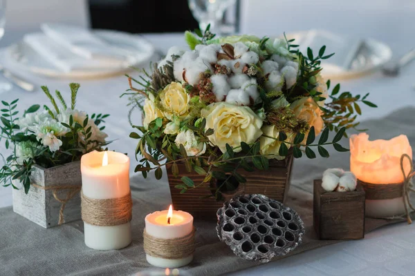 wedding table decoration, candles, flowers in a vase