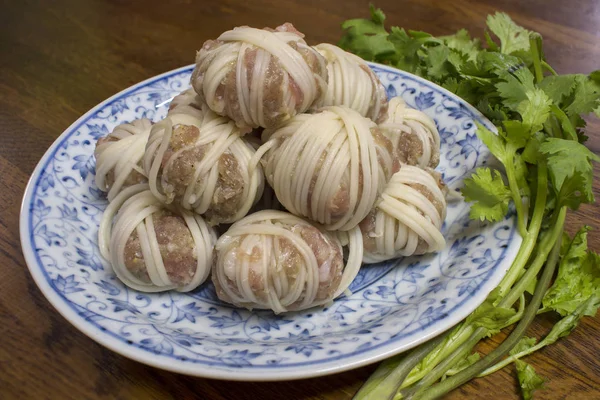 Mhoo sarong  (Deep fried wrapped pork ball with noodle) menu is Thai food. Made from grated pork wrapped in vermicelli. This image was taken before frying.