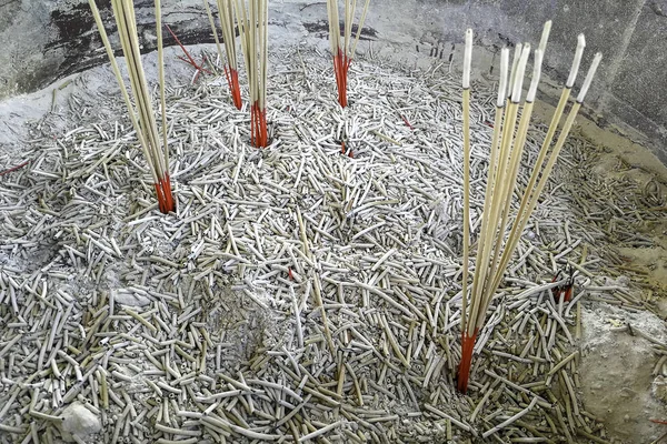 Burning incense sticks in joss stick pot