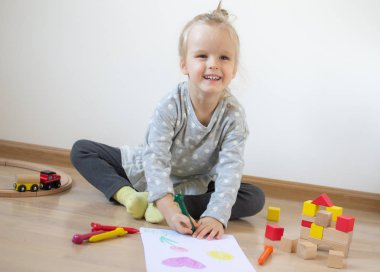 Beyaz kız eve erken eğitim okul okul öncesi geliştirme çocuk oyunu için hazırlanıyor, renkli kalem boyama