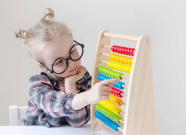 Caucasian little girl with round glasses. Little teacher. Funny glasses humor. Retro style