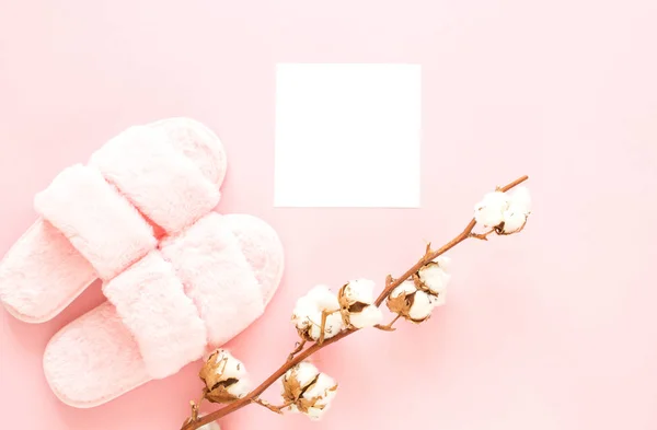 Composition of faux fur slippers on a light pink background. Healthy morning concept. Flat Lay. Top View