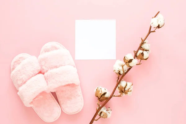 Composition of faux fur slippers on a light pink background. Healthy morning concept. Flat Lay. Top View