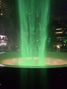 SINGAPORE - 18 May, 2025: Night view of parallax view of indoor Singapore rain vortex dome waterfall.