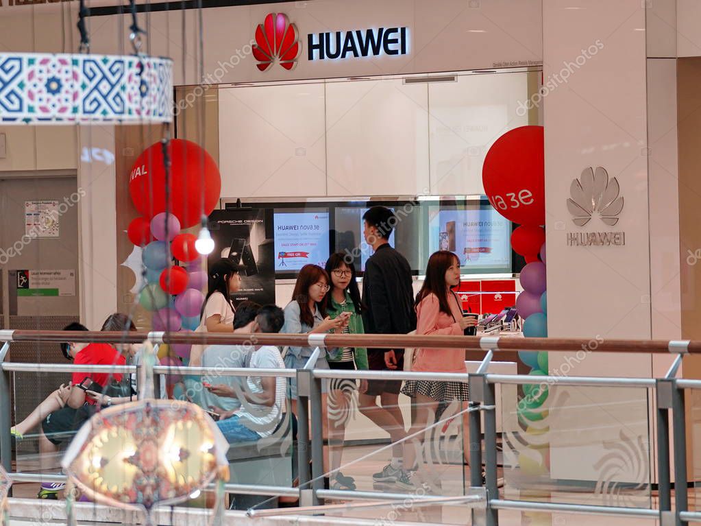 Kuala Lumpur, Malaysia - June 15, 2018: People walk past a Huawei store in a shopping mall