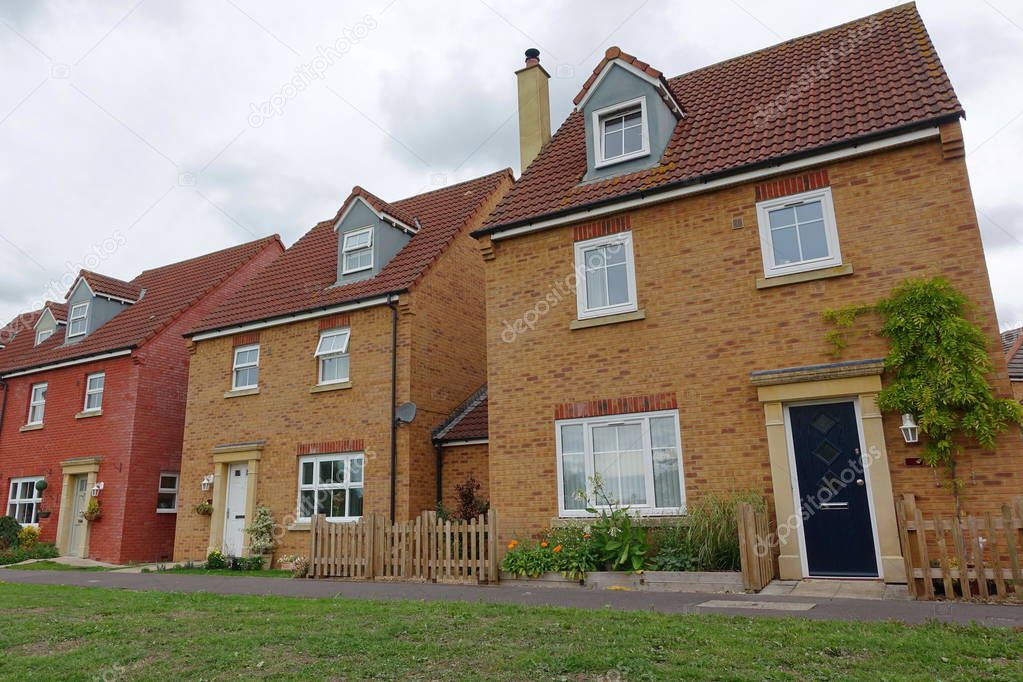 Exterior View of Terraced Red Brick Houses on Typical English Residential Estate