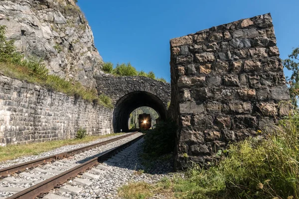 The train is traveling in a tunnel on the Circum-Baikal Railway