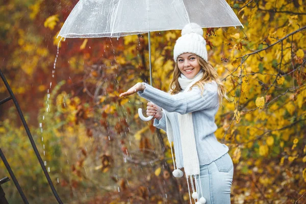 Young woman with umbrella in autumn nature