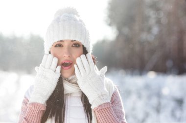 Surprised young woman outdoors in winter clipart