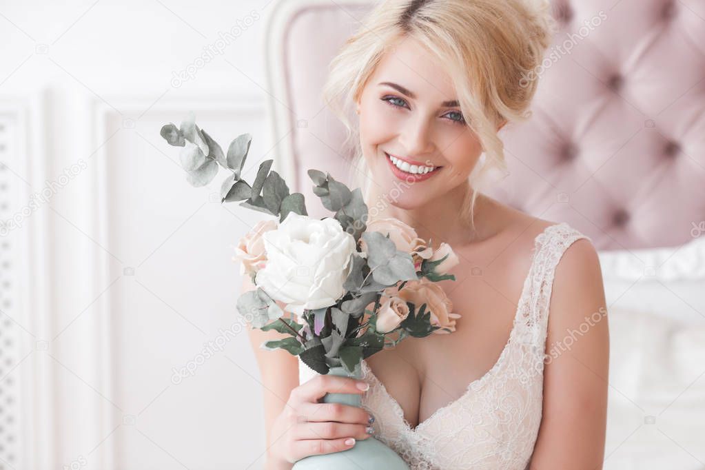 Blonde young beautiful woman posing indoors