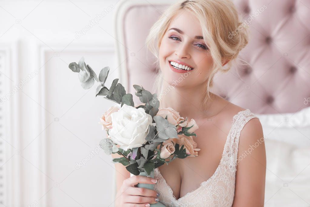 Blonde young beautiful woman posing indoors