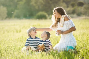 Genç güzel anne çocuklarıyla piknik yapıyor.. 