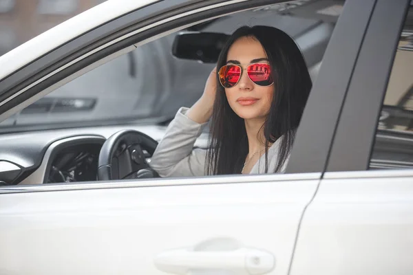 stock image Confident woman in automobile. Lady driving a car. Young beautiful female sitting in the auto. Urban woman.