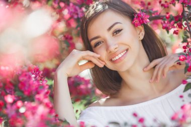 Close up portrait of young beautiful woman with perfect smooth skin. Attractive lady in flowers. Facial portrait of beautiful female. clipart