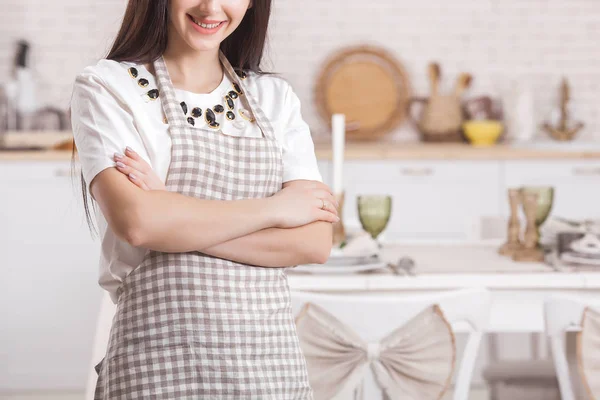 Young housewife on kitchen background. Woman at home kitchen. Female cooking with copy space.