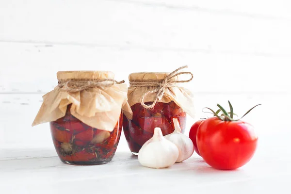 Tomatoes in the jar. Homemade sun dried tomatoes. temporary closing-down. Summer and autumn canned food. conserve with spices and vegetables.