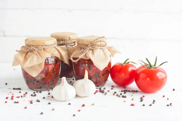 Tomatoes in the jar. Homemade sun dried tomatoes. temporary closing-down. Summer and autumn canned food. conserve with spices and vegetables.