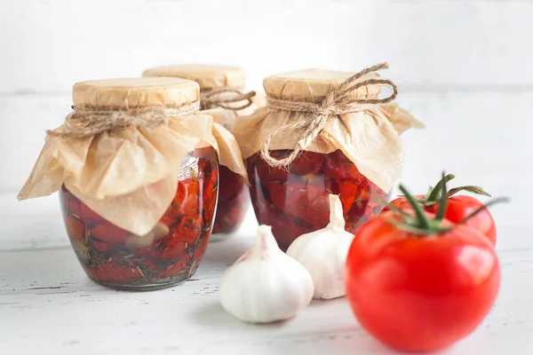 Tomatoes in the jar. Homemade sun dried tomatoes. temporary closing-down. Summer and autumn canned food. conserve with spices and vegetables.