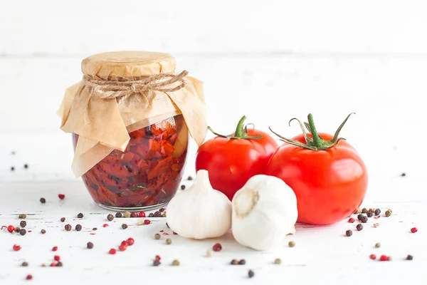 Tomatoes in the jar. Homemade sun dried tomatoes. temporary closing-down. Summer and autumn canned food. conserve with spices and vegetables.