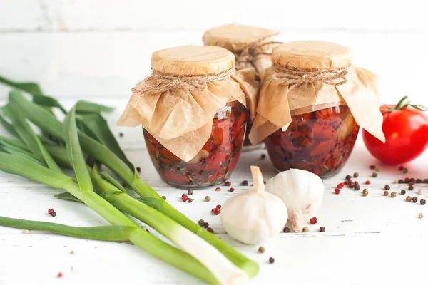 Tomatoes in the jar. Homemade sun dried tomatoes. temporary closing-down. Summer and autumn canned food. conserve with spices and vegetables.