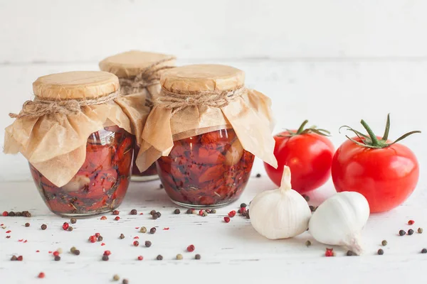 Tomatoes in the jar. Homemade sun dried tomatoes. temporary closing-down. Summer and autumn canned food. conserve with spices and vegetables.