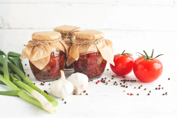 Tomatoes in the jar. Homemade sun dried tomatoes. temporary closing-down. Summer and autumn canned food. conserve with spices and vegetables.