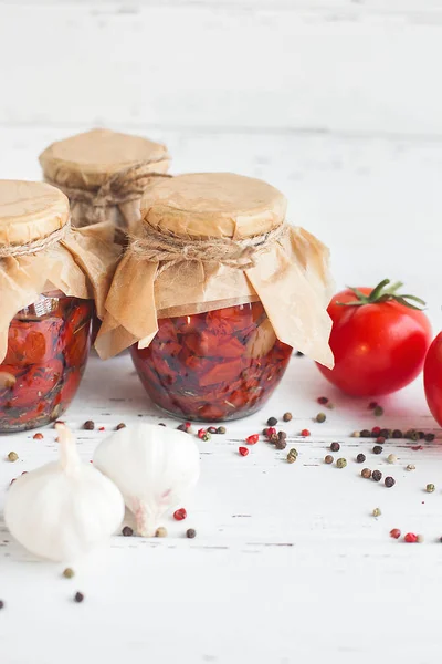 Tomatoes in the jar. Homemade sun dried tomatoes. temporary closing-down. Summer and autumn canned food. conserve with spices and vegetables.