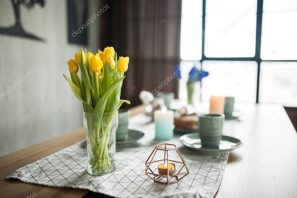 Table with cups and plates on rustic background. Loft interior.