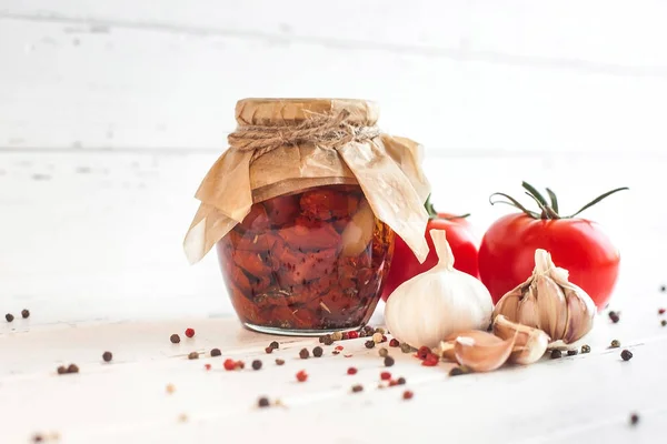 Tomatoes in the jar. Homemade sun dried tomatoes. temporary closing-down. Summer and autumn canned food. conserve with spices and vegetables. — Stock Image Tomatoes Jar Homemade Sun Dried Tomatoes Temporary Closing Summer Autumn Royalty Free Stock Photos