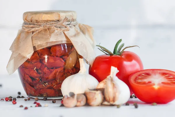 Tomatoes in the jar. Homemade sun dried tomatoes. temporary closing-down. Summer and autumn canned food. conserve with spices and vegetables.