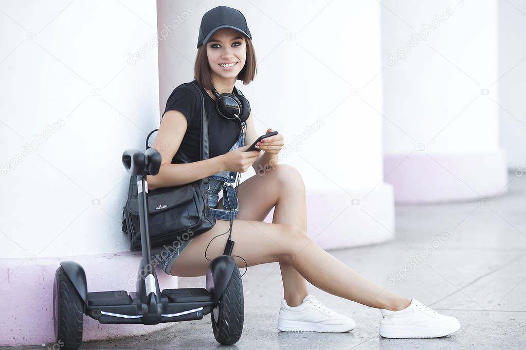 Young attractive woman skating on segway. Pretty female riding a gyroboard.