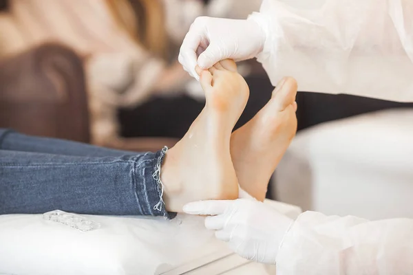 Pedicure in the salon. Master of pedicure doing a procedure for her client. Foot care procedure.