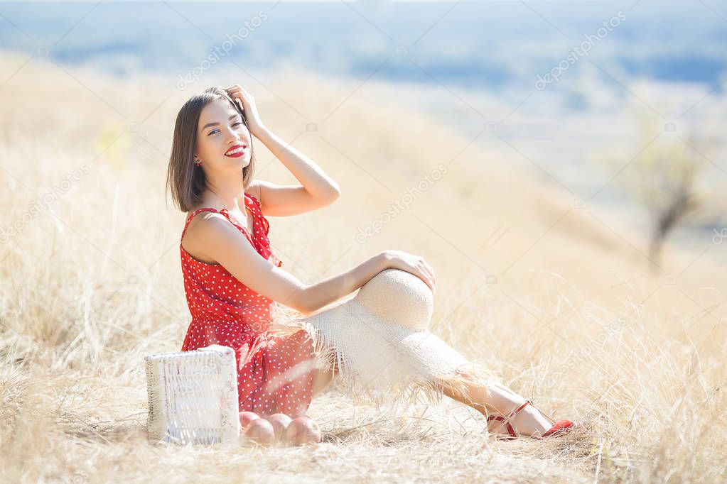 Young beautiful woman portrait outdoors on juicy summer or autumn background. Female on fall time. Lady on the nature wearing red stylish dress.