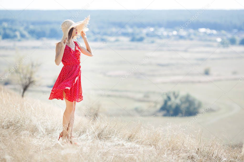 Young beautiful woman portrait outdoors on juicy summer or autumn background. Female on fall time. Lady on the nature wearing red stylish dress.