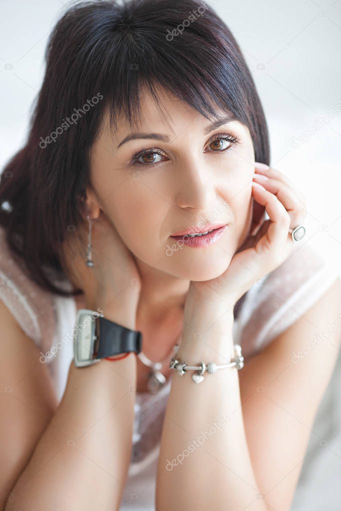 Adult woman interior portrait. Mature female indoors. Cheerful woman closeup portrait. Lady at home.