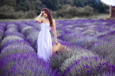 Lavanta tarlasında genç ve güzel bir kadın. Yaz arkaplanındaki kadın