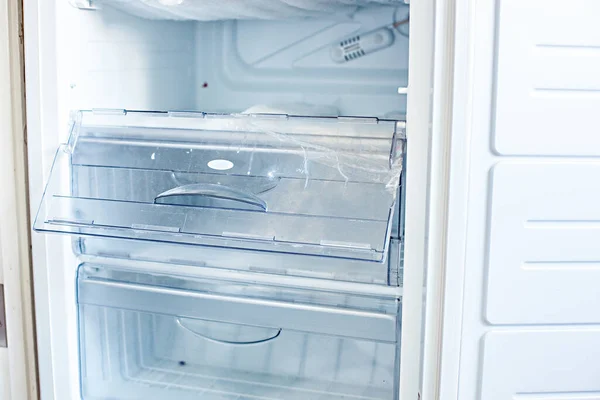 Broken fridge. defrosted refrigerator. Open freezer