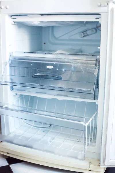 Broken fridge. defrosted refrigerator. Open freezer