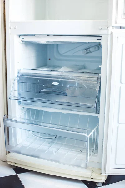 Broken fridge. defrosted refrigerator. Open freezer