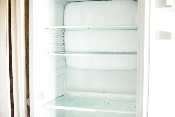Broken fridge. defrosted refrigerator. Open freezer