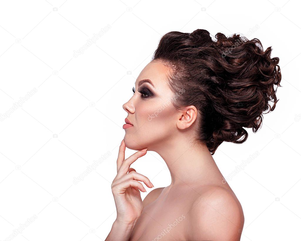 Young woman with glamorous makeup and high fashion hairstyle on white background