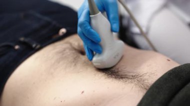 Eldivenli el karın ultrasonu tarama prosedürü uyguluyor