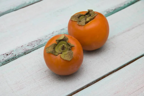 stock image fresh persimmon on a wooden background fruit