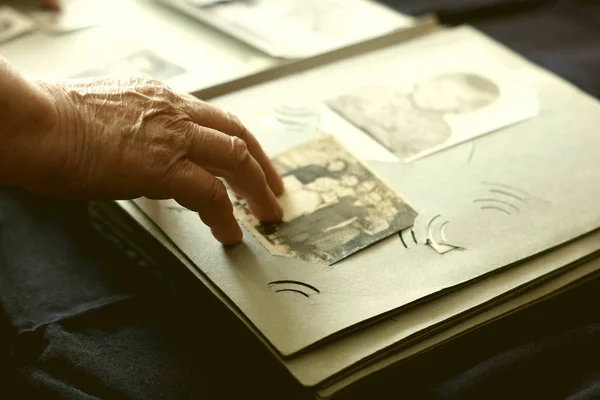 Old woman looking for old photos