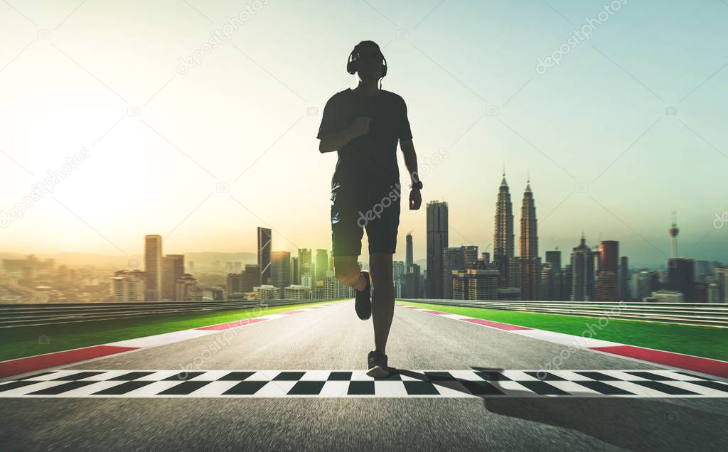 Athlete running on start and finish line street with city skyline background, sport motivation concept 