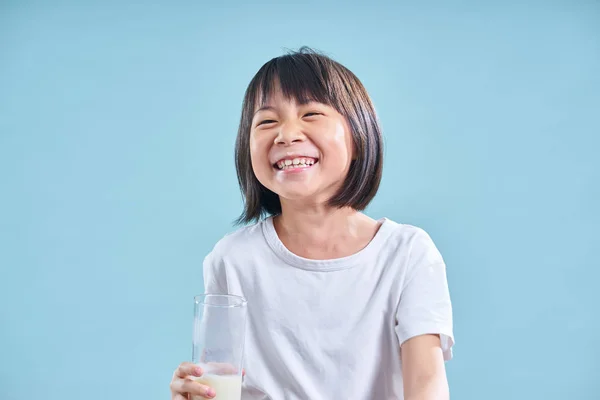 Adorable Smart Asian Little Girl Happy Drinking Milk Blue Background — Stock Photo, Image