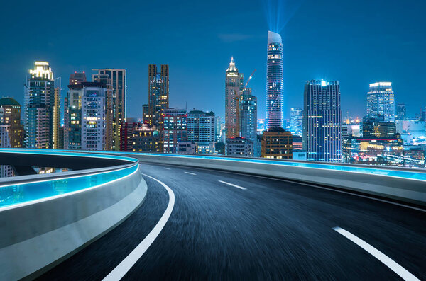Curvy flyover highway moving forward road with Bangkok cityscape night scene view . motion blur effect apply