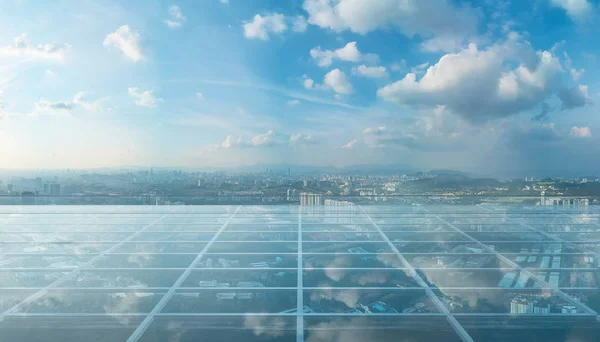 Empty transparent glass floor on rooftop with city skyline