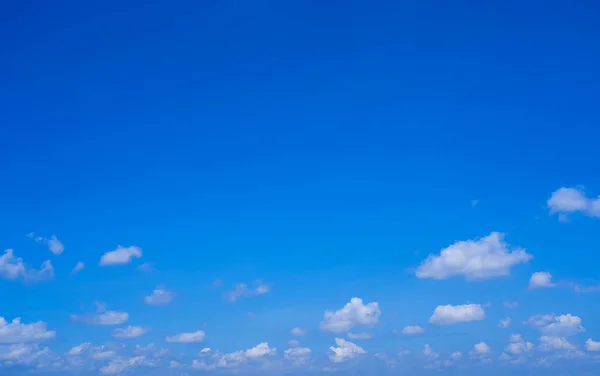 Beautiful and clean blue sky with fluffy white clouds, summer sky background.
